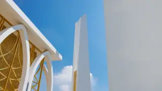 Ilustrasi: Struktur arsitektur modern berwarna putih dan emas di bawah langit biru cerah.