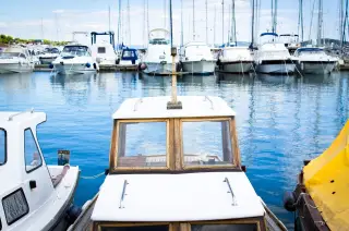 Ilustrasi: Sejumlah kapal motor dan yacht bersandar di perairan pelabuhan marina yang tenang.